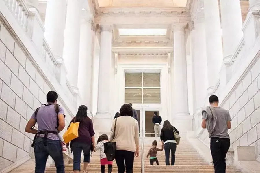 Visitors climb the main staircase of the Asian Art Museum